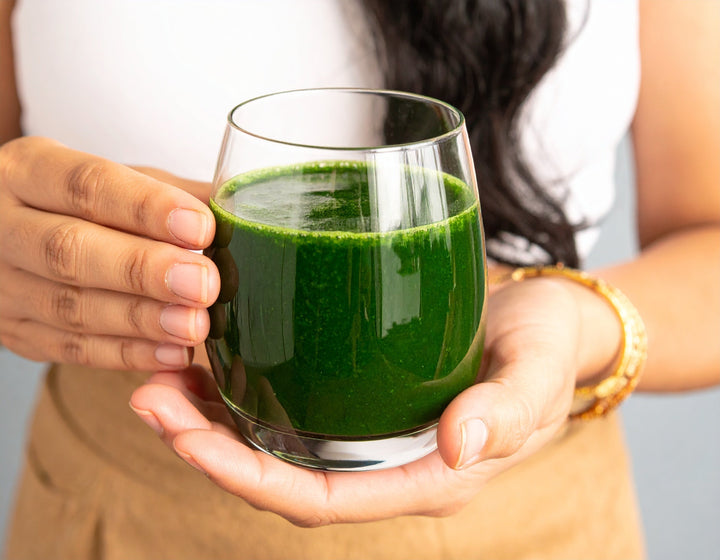 Person enjoying a smoothie made with spirulina, a great visual for understanding what is spirulina powder used for.