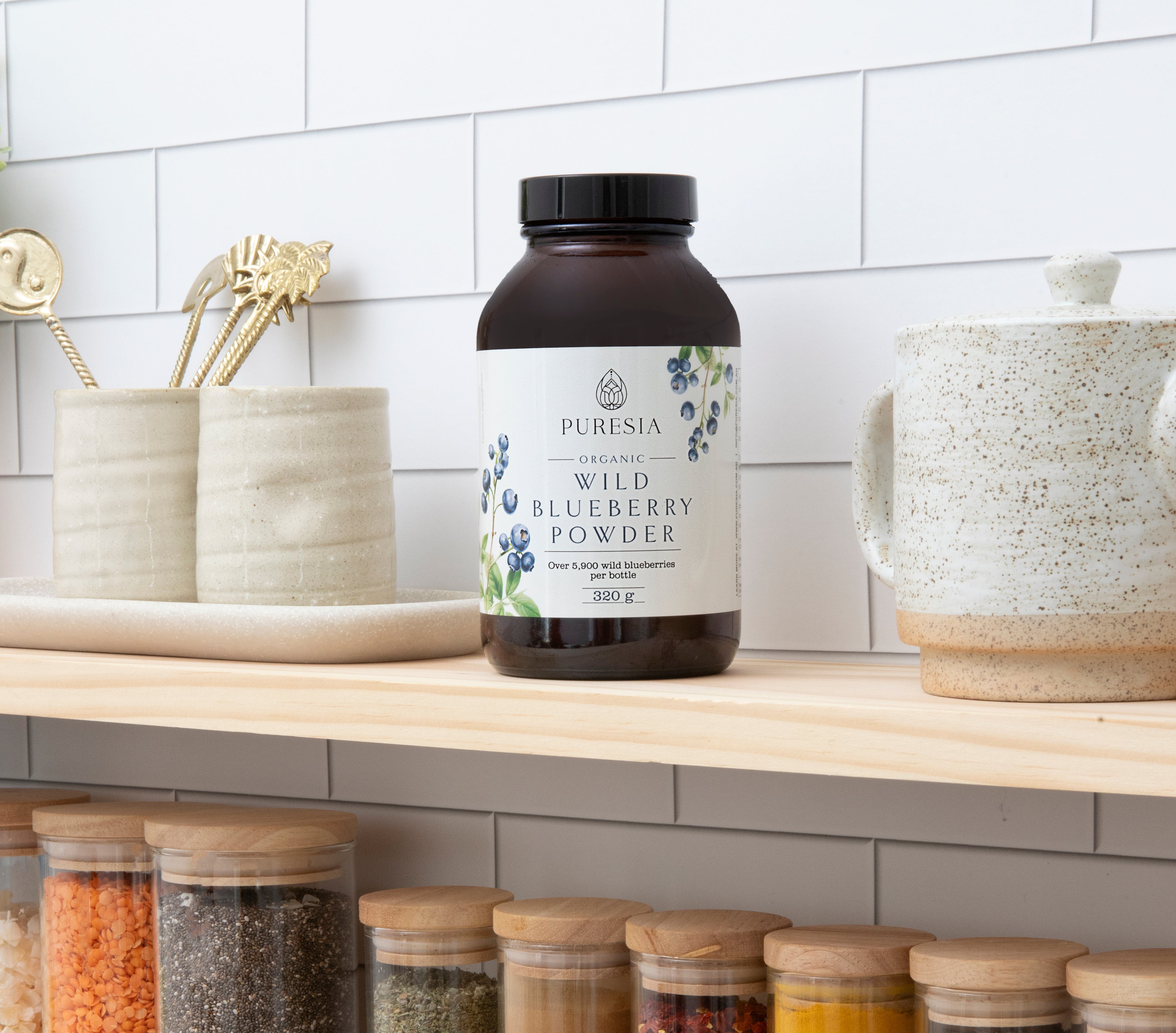 Bottle of wild blueberry powder sitting on a pantry shelf, good antioxidant rich food